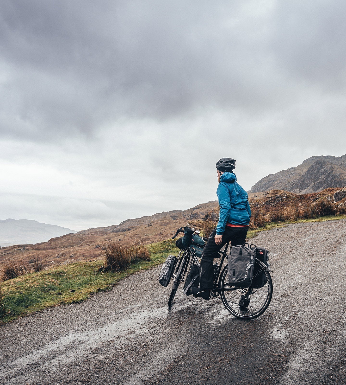 Man on touring bike on a quiet road in North Wales