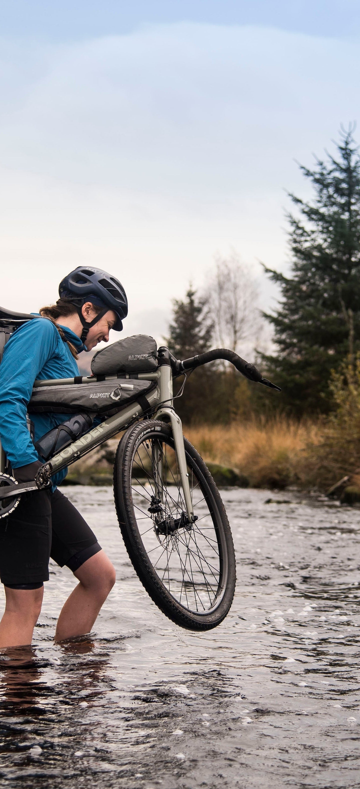 Fording a river with a gravel bike on a bikepacking adventure