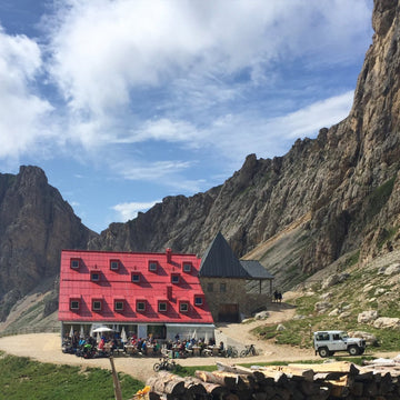 A man and woman hiking in the woods with backpacks on looking at their map
