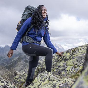 A man and a women trekking in Merino wool base layers in the French Alps