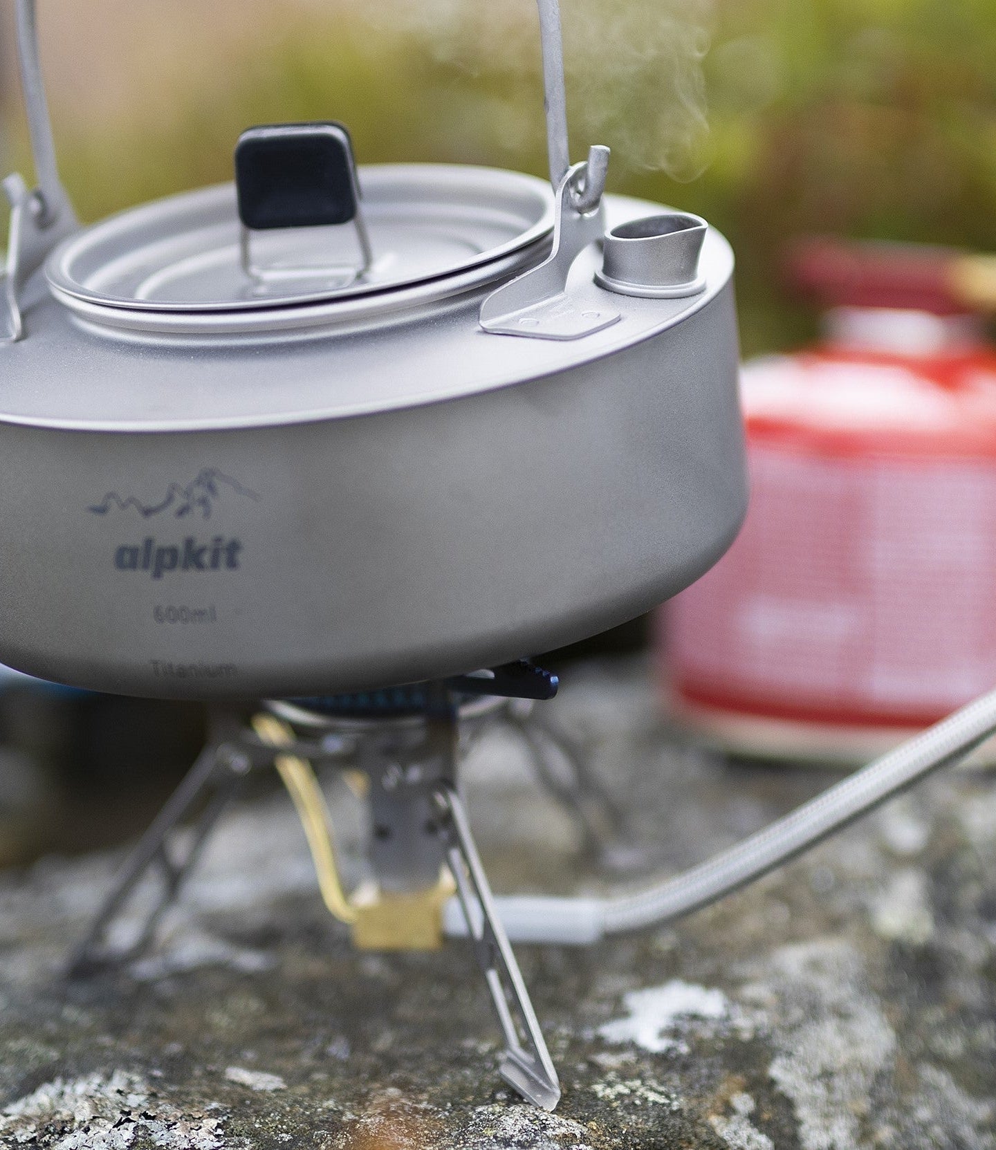 Camping gas canister attached to a camping stove