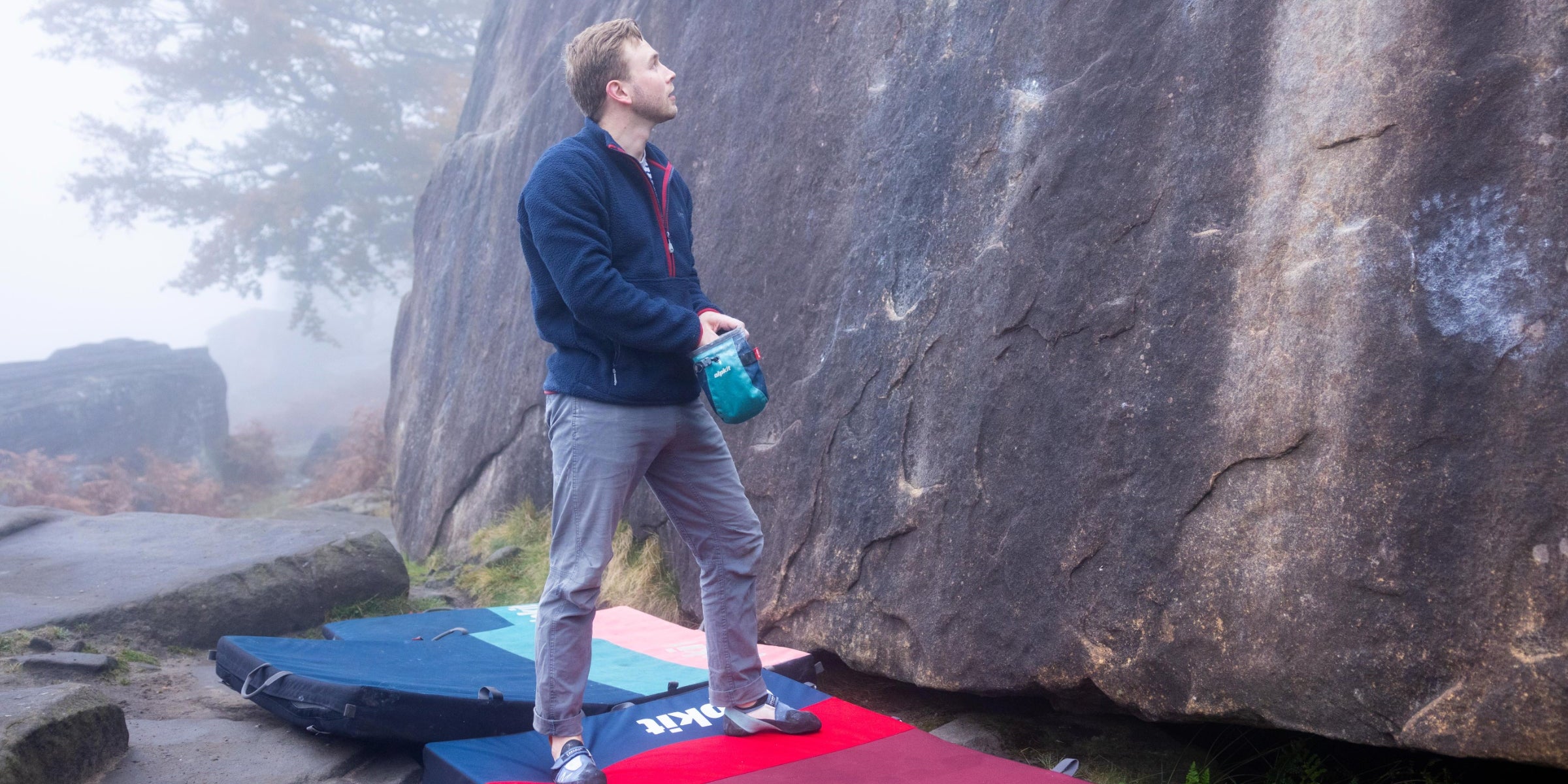 Bouldering above crash pads in the Peak District