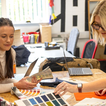 Campers sat outside a cotton teepee tent in Scotland