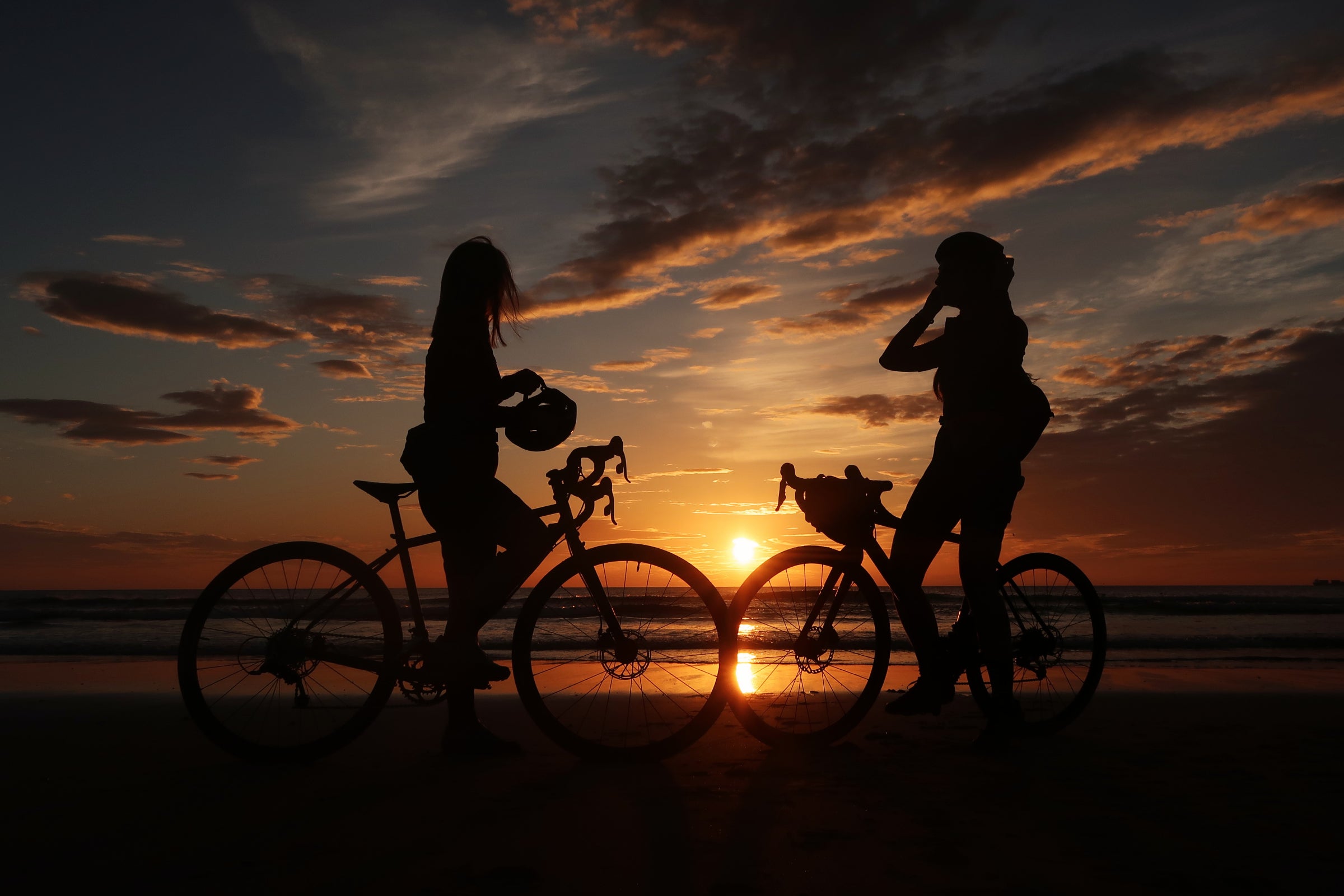 Cyclists enjoying the sunset at the end of a C2C route