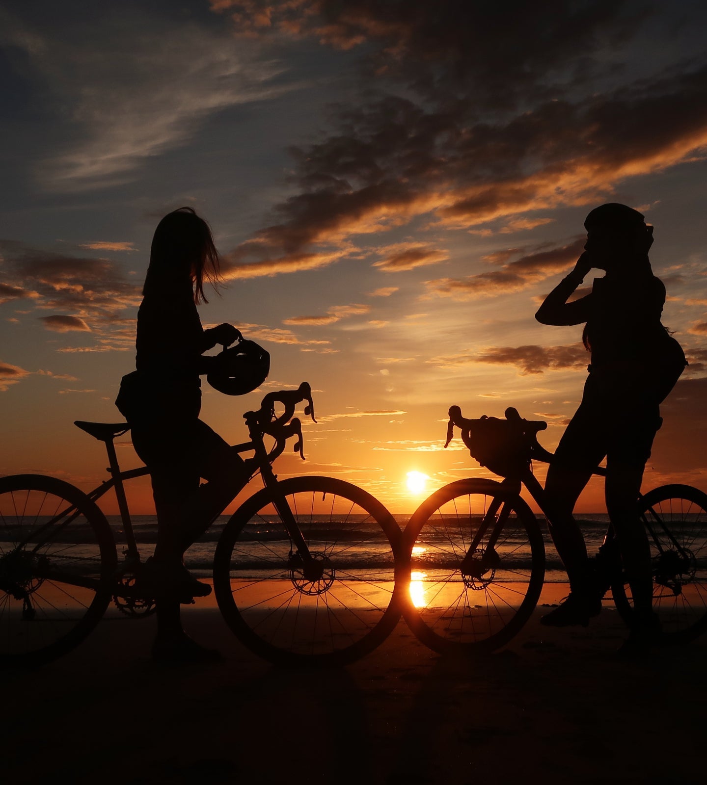 Cyclists enjoying the sunset at the end of a C2C route