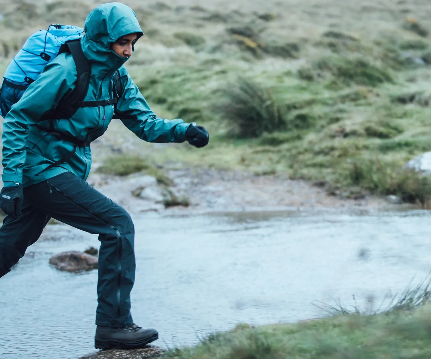 Hillwalker crossing a stream