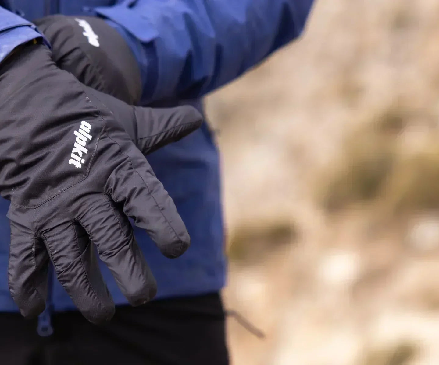 Hillwalker pulls on insulated gloves