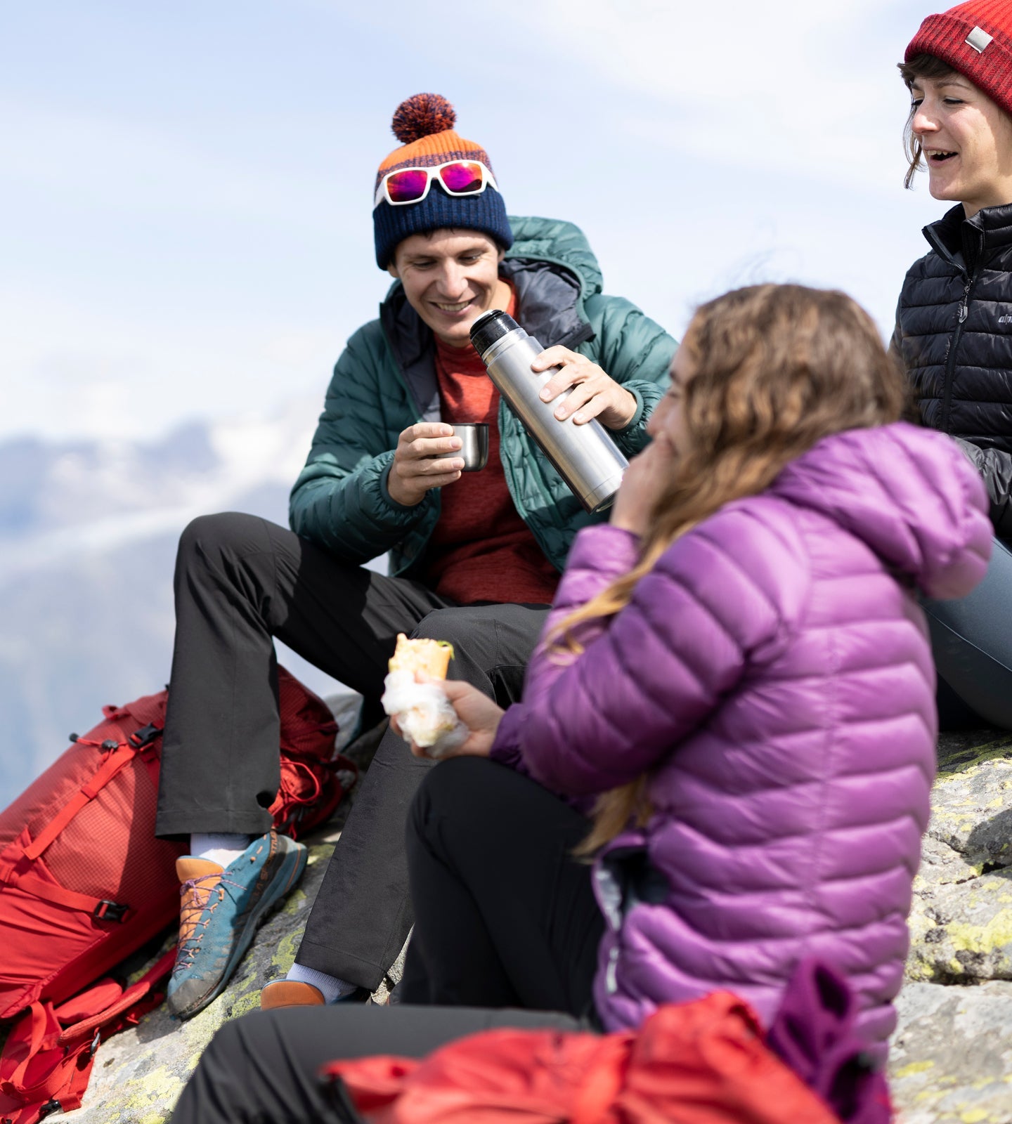 Popping on a down jacket during a break hillwalking