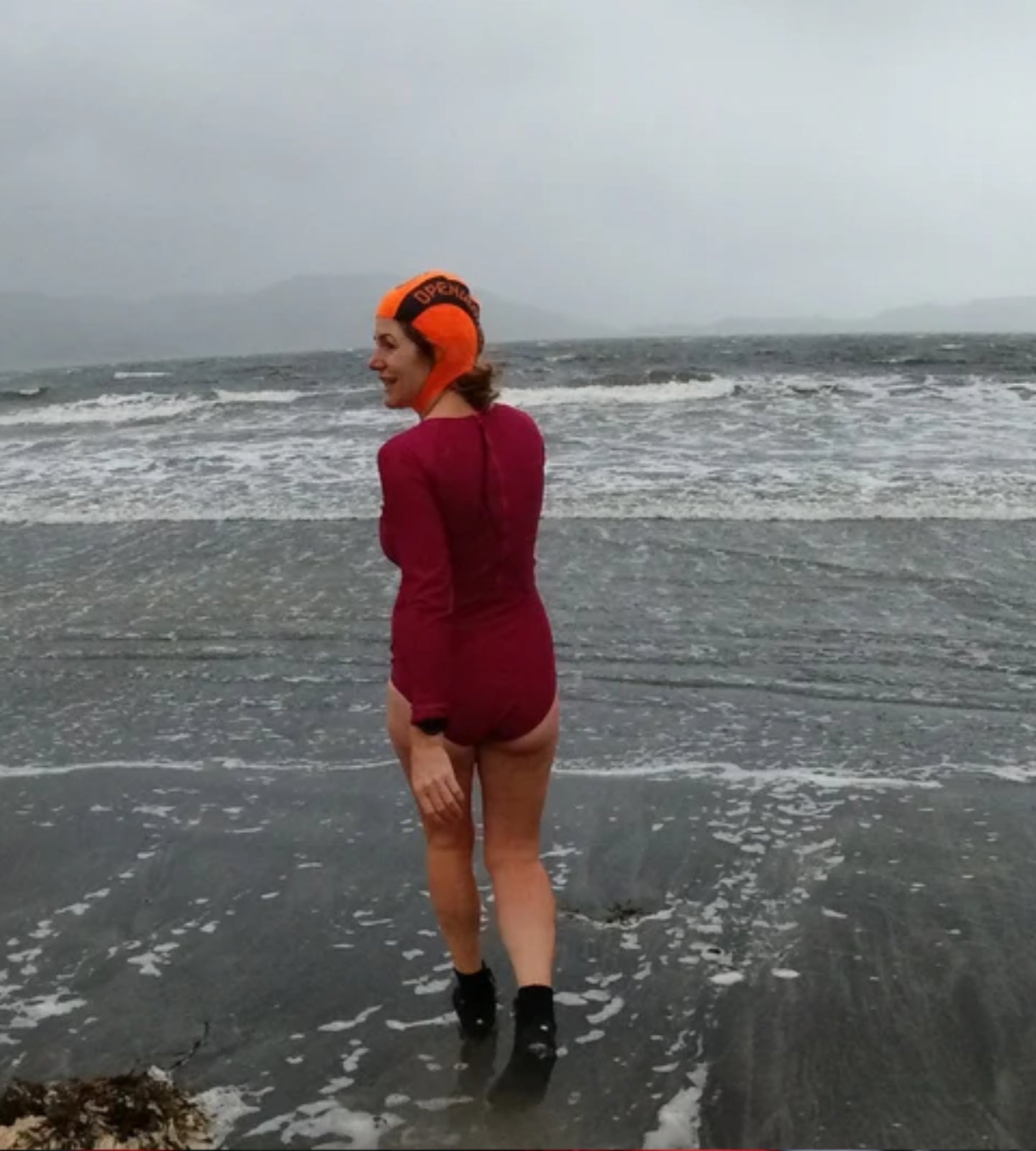 Wild swimmer entering the sea