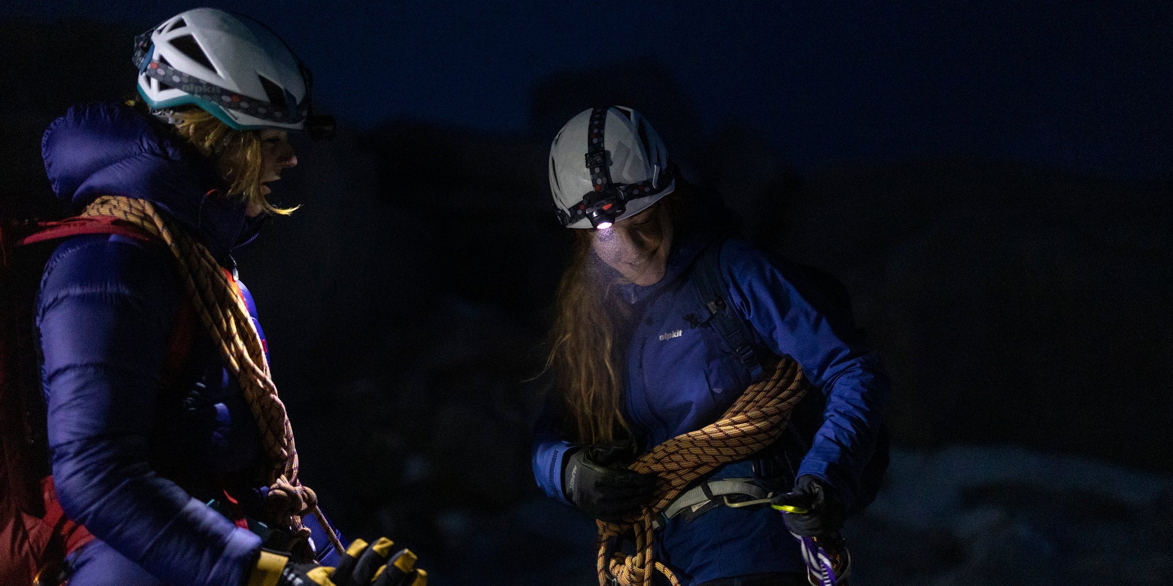 Two night time climbers wearing headtorches