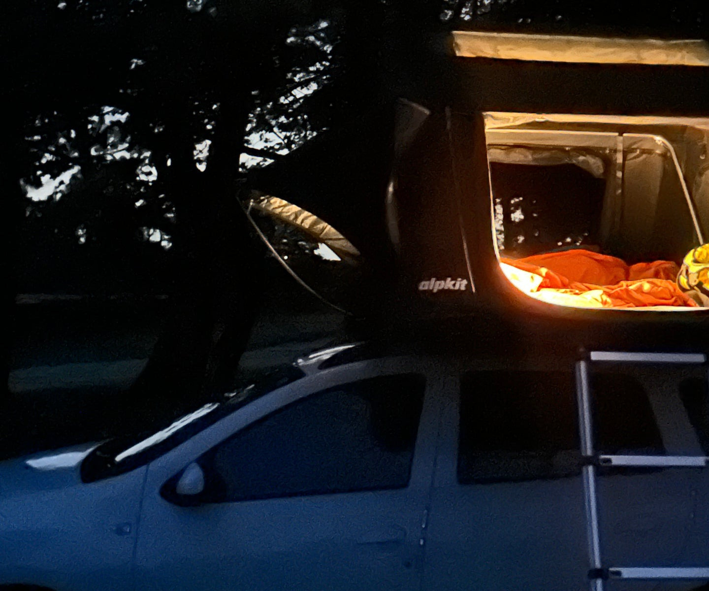 Roof tent lit by lamplight