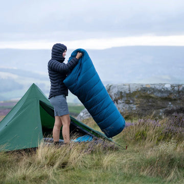 Camper preparing his sleeping bag