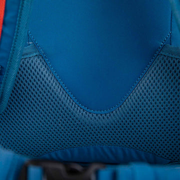 A man and woman hiking in the woods with backpacks on looking at their map