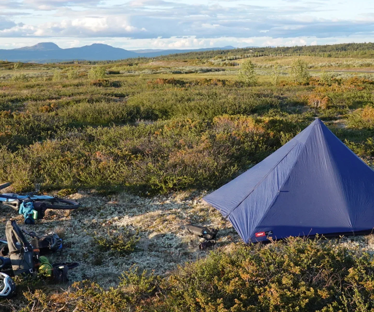 Jacob Webb bikepacking with a lightweight pyramid tarp