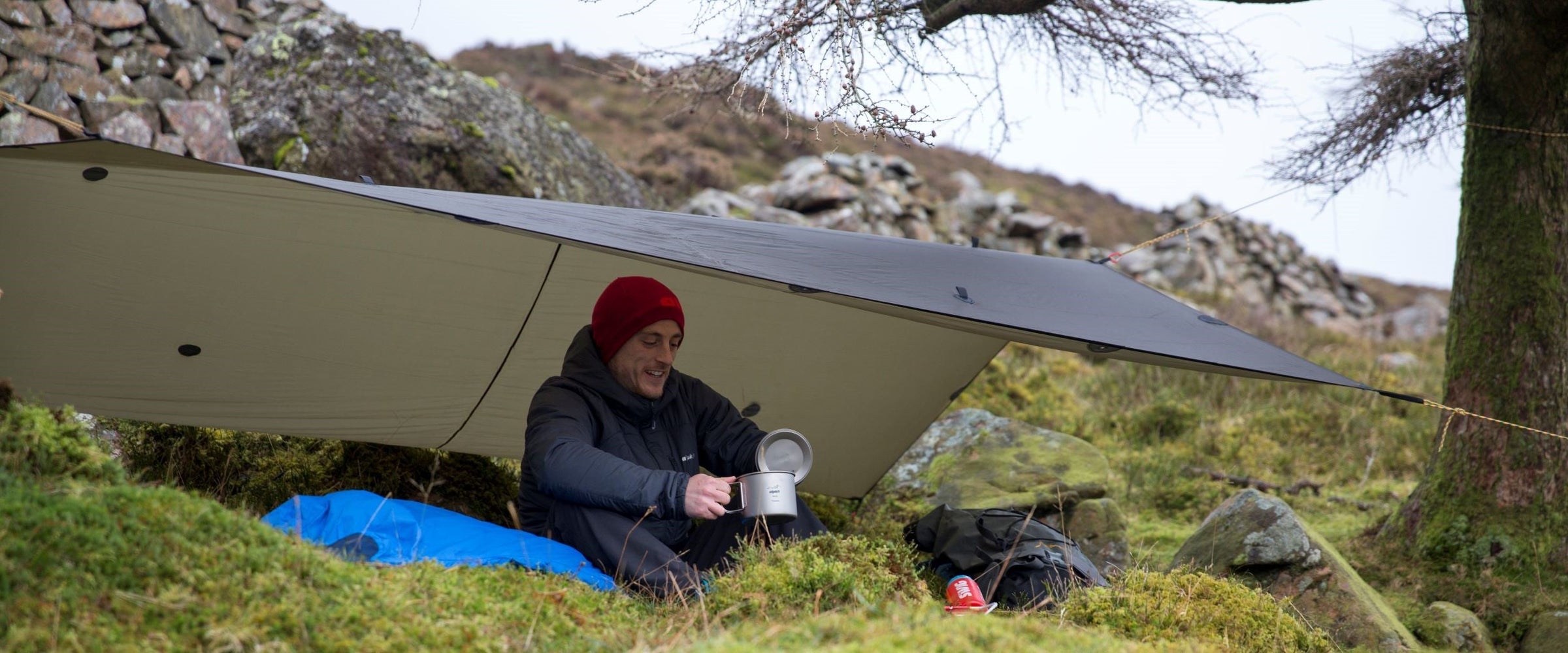 Wild camping under a lightweight tarp with a titanium cooking pot