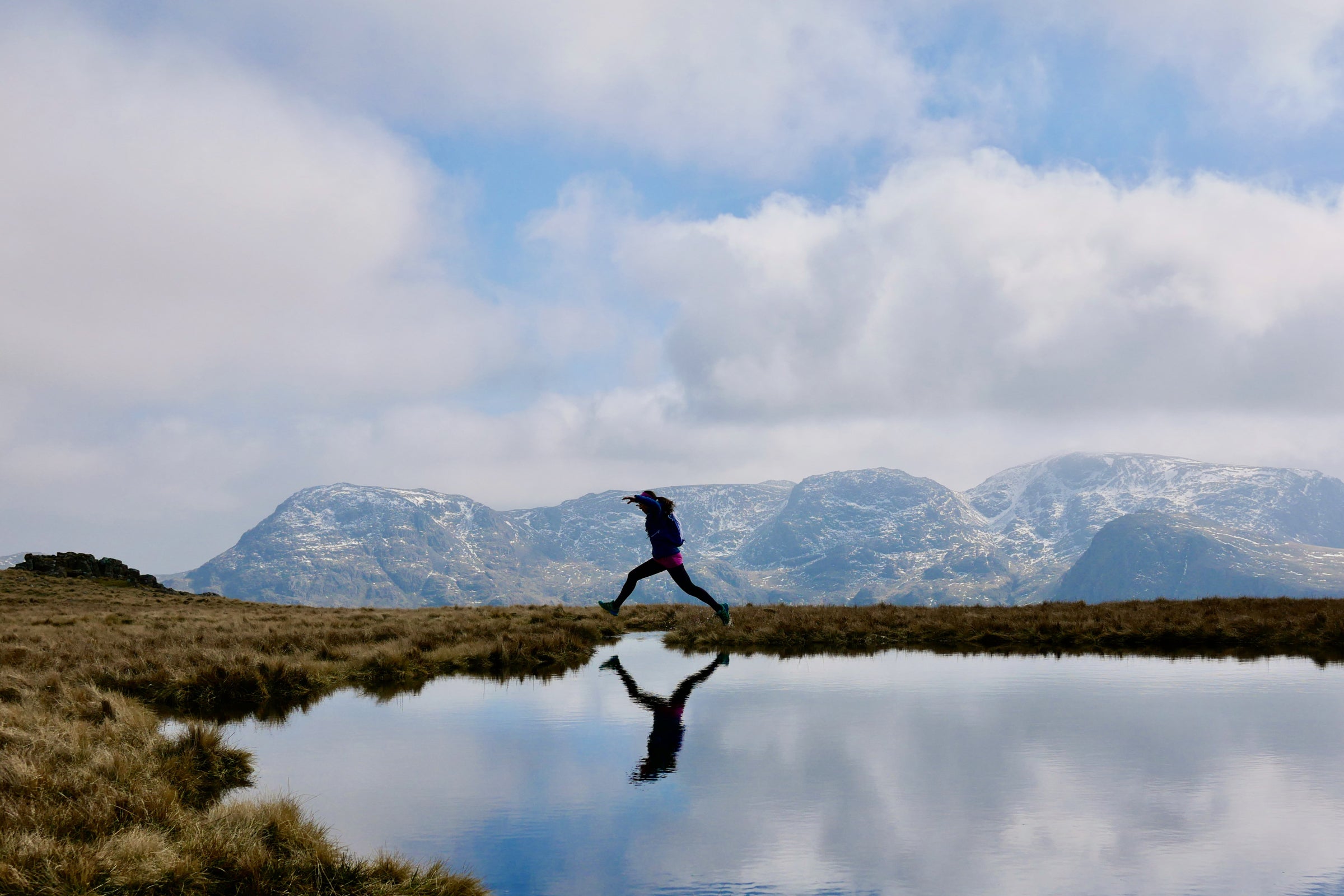 Female trail runner in the winter mountains