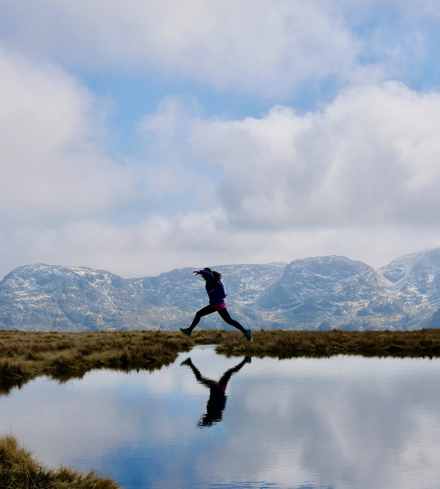 Female trail runner in the winter mountains
