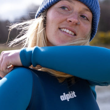Swimmer wading out into a sea loch