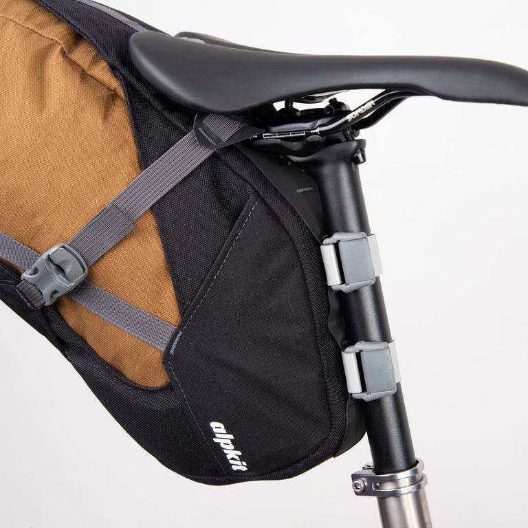 alpkit big papa 17 litre seatpack for bikepacking in mountain brown seatpost straps