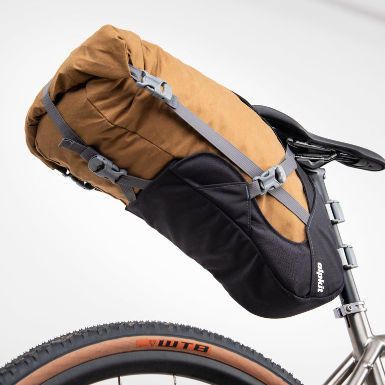 alpkit big papa 17 litre seatpack for bikepacking in mountain brown bottom