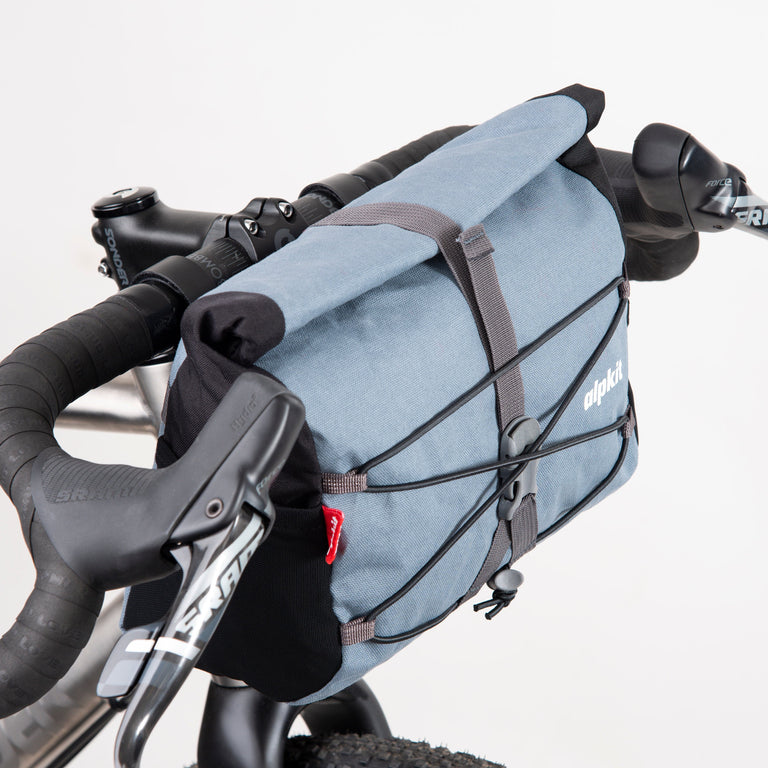 alpkit gravel bag handlebar bag for drop bars in storm grey roll top