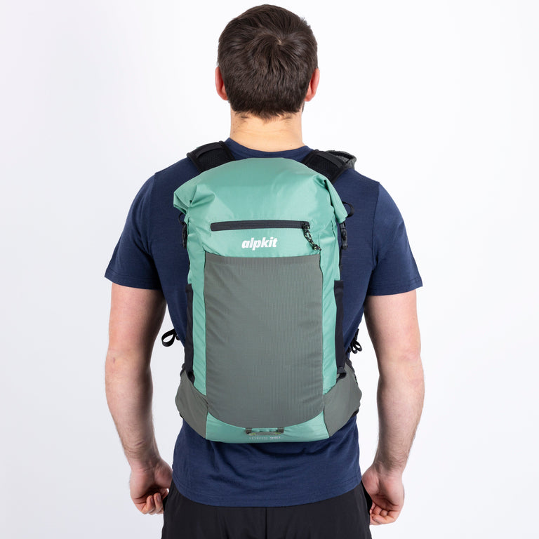 Person wearing a green and gray backpack