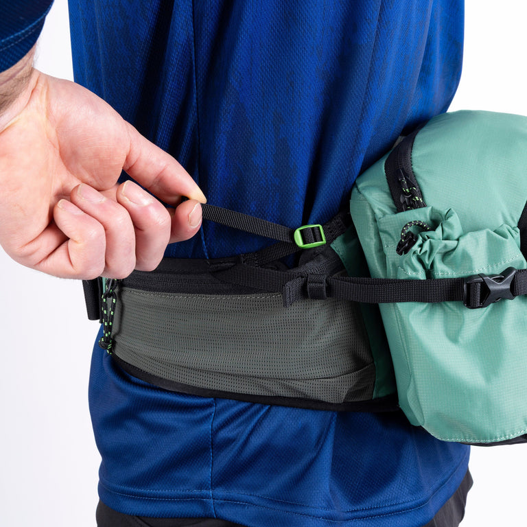 Vora 6L hip pack adjusting the fit while wearing
