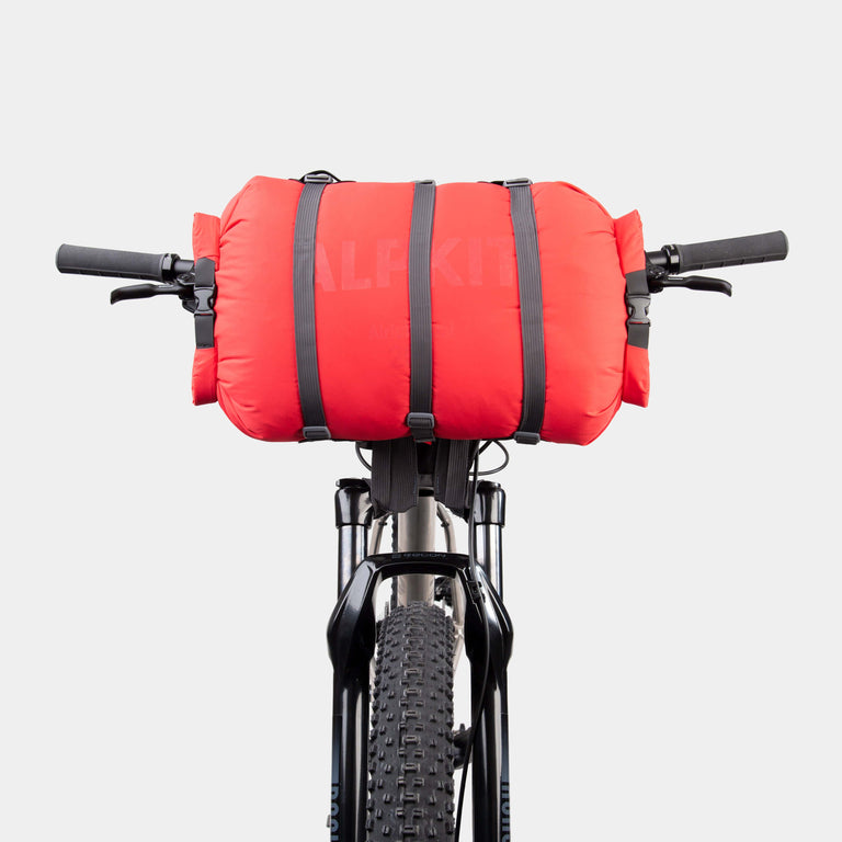 alpkit manga bikepacking handlebar harness for flat bar bikes in black with airlock dual drybag