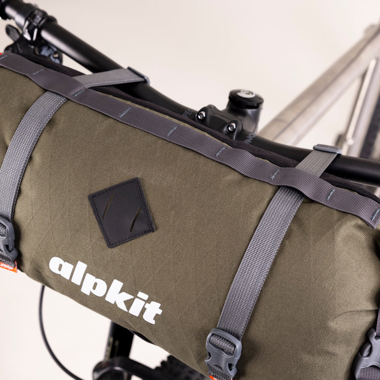 alpkit kuoka handlebar bag for bike packing in olive green logo straps