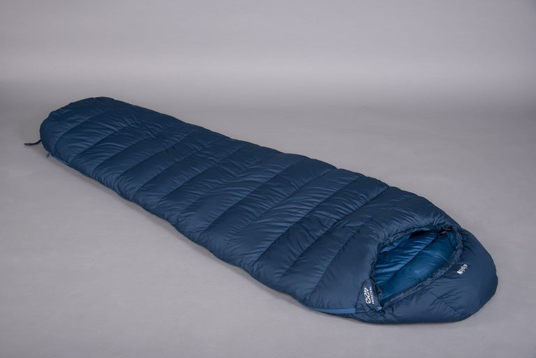 Pipedream 400 lightweight 3 season sleeping bag in blue laid on the floor with a grey background